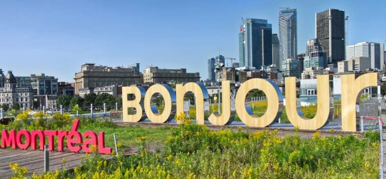 Schriftzug von Montreal mit Blick auf die Hochhäuser.